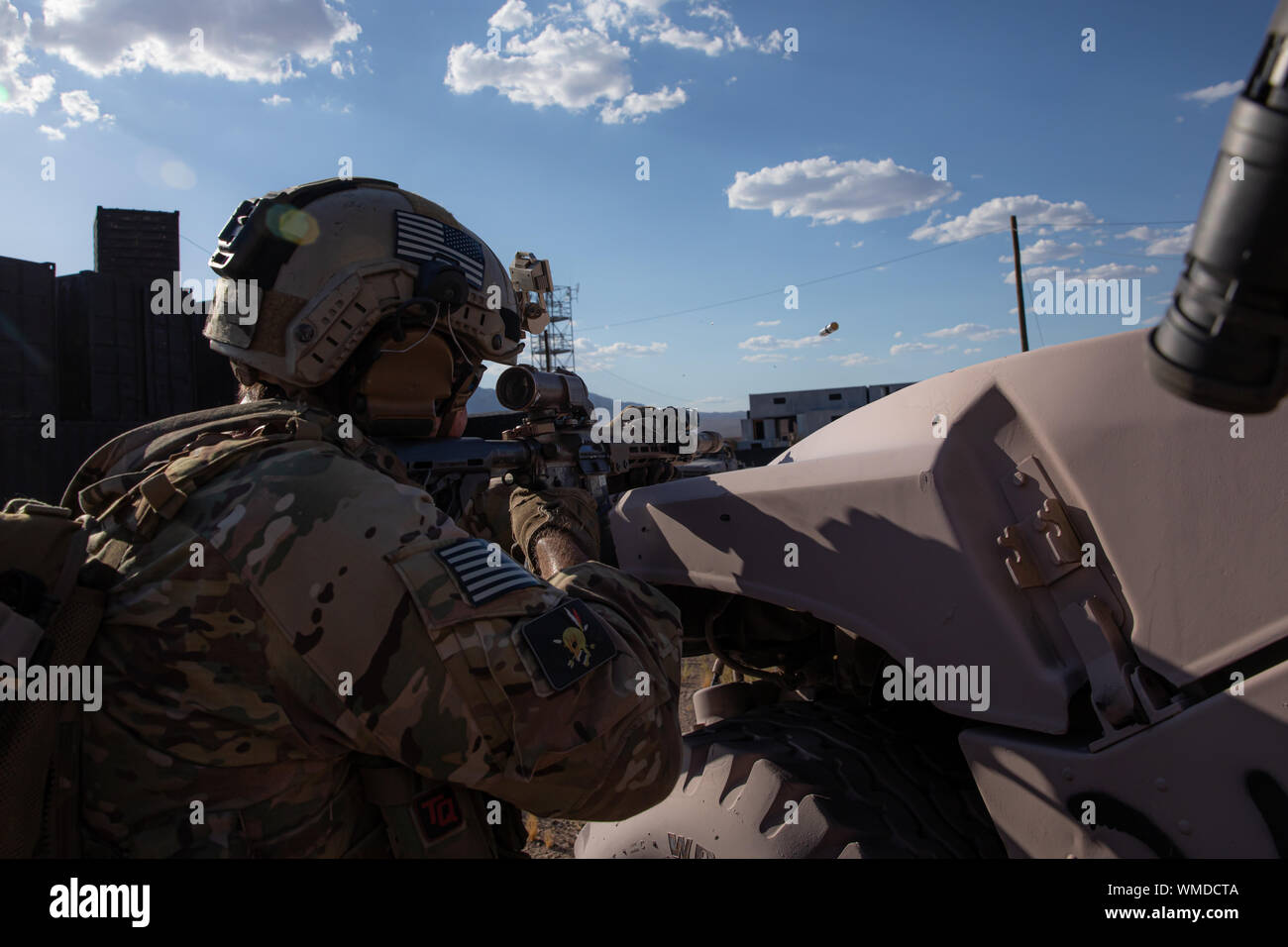 A Green Beret assigned to 3rd Special Forces Group (Airborne) fires his weapon while clearing a compound during a training event near Nellis Air Force Base, Nev. Aug. 27, 2019. U.S. Special Forces and U.S. Air Force Joint Terminal Attack Controllers conducted a raid and utilized multiple weapon systems ranging from smalls arms weapons to A-10 Thunderbolt ll aircraft. (U.S. Army photo by Sgt. Steven Lewis) Stock Photo