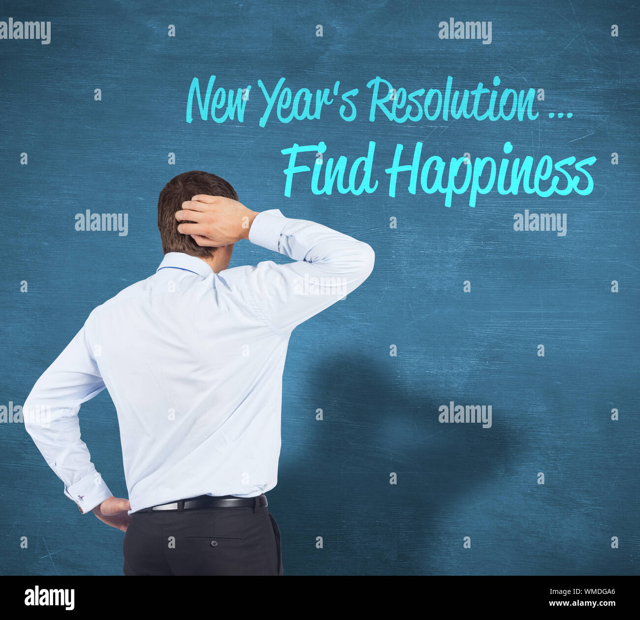 Thinking businessman scratching head against blue chalkboard Stock Photo