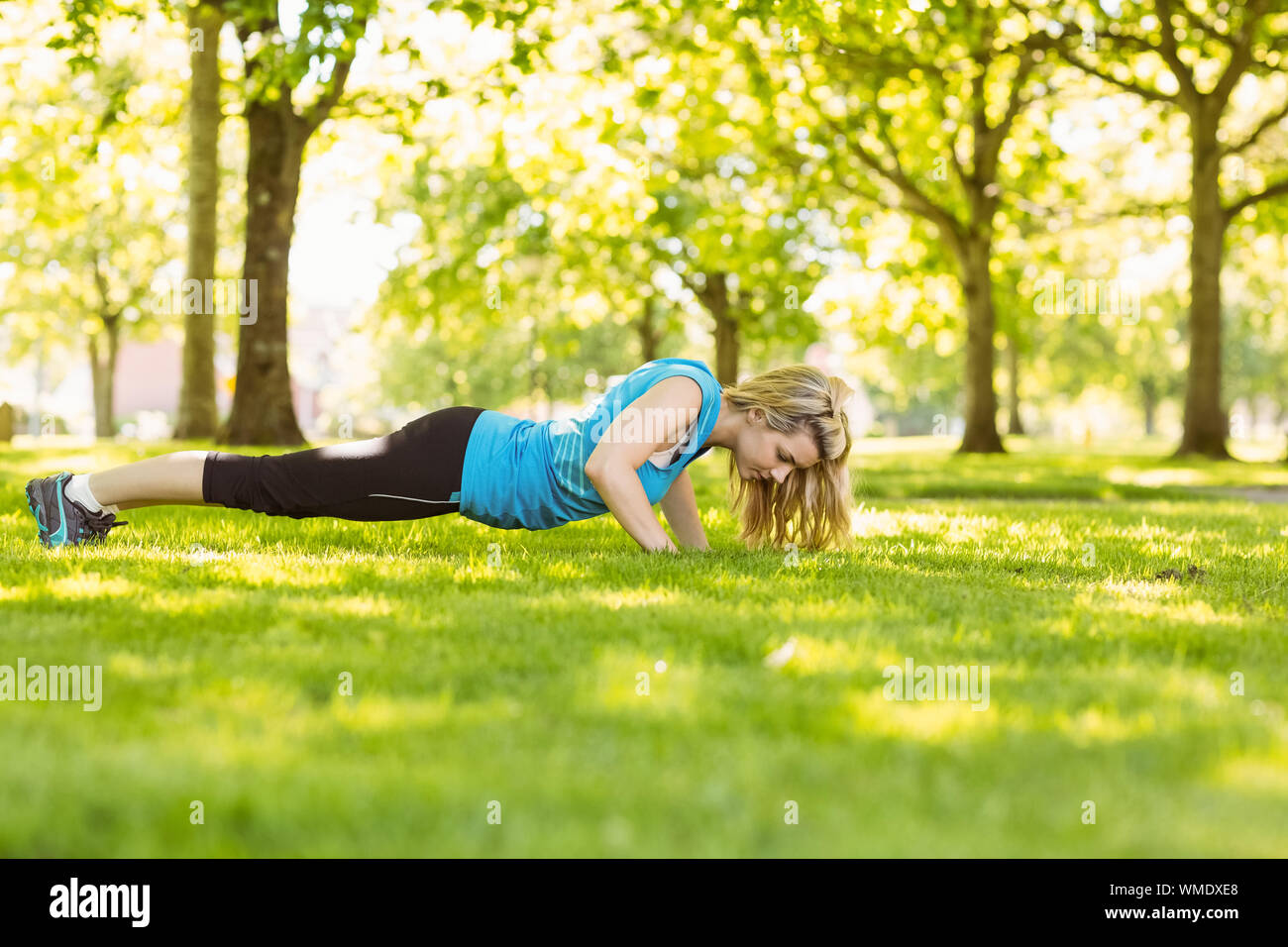 Woman doing push up on grass hi-res stock photography and images - Alamy