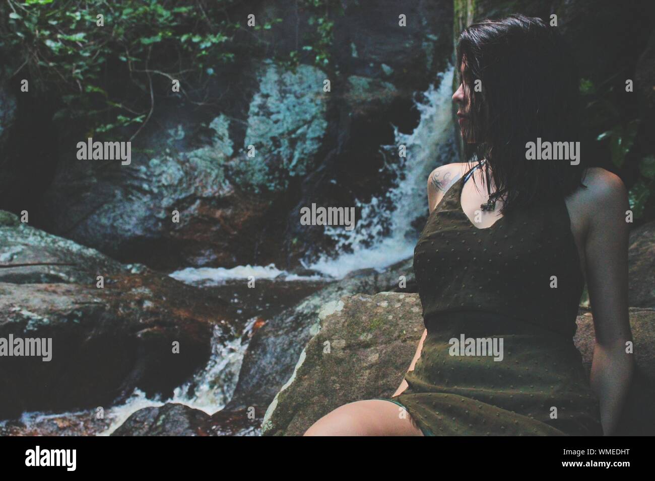 Woman leaning on rocks hi-res stock photography and images - Alamy