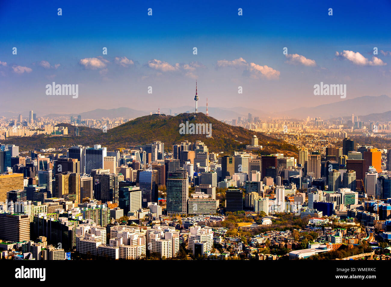 Distant View Of N Seoul Tower On Namsan Mountain Amidst Cityscape Against Sky Stock Photo