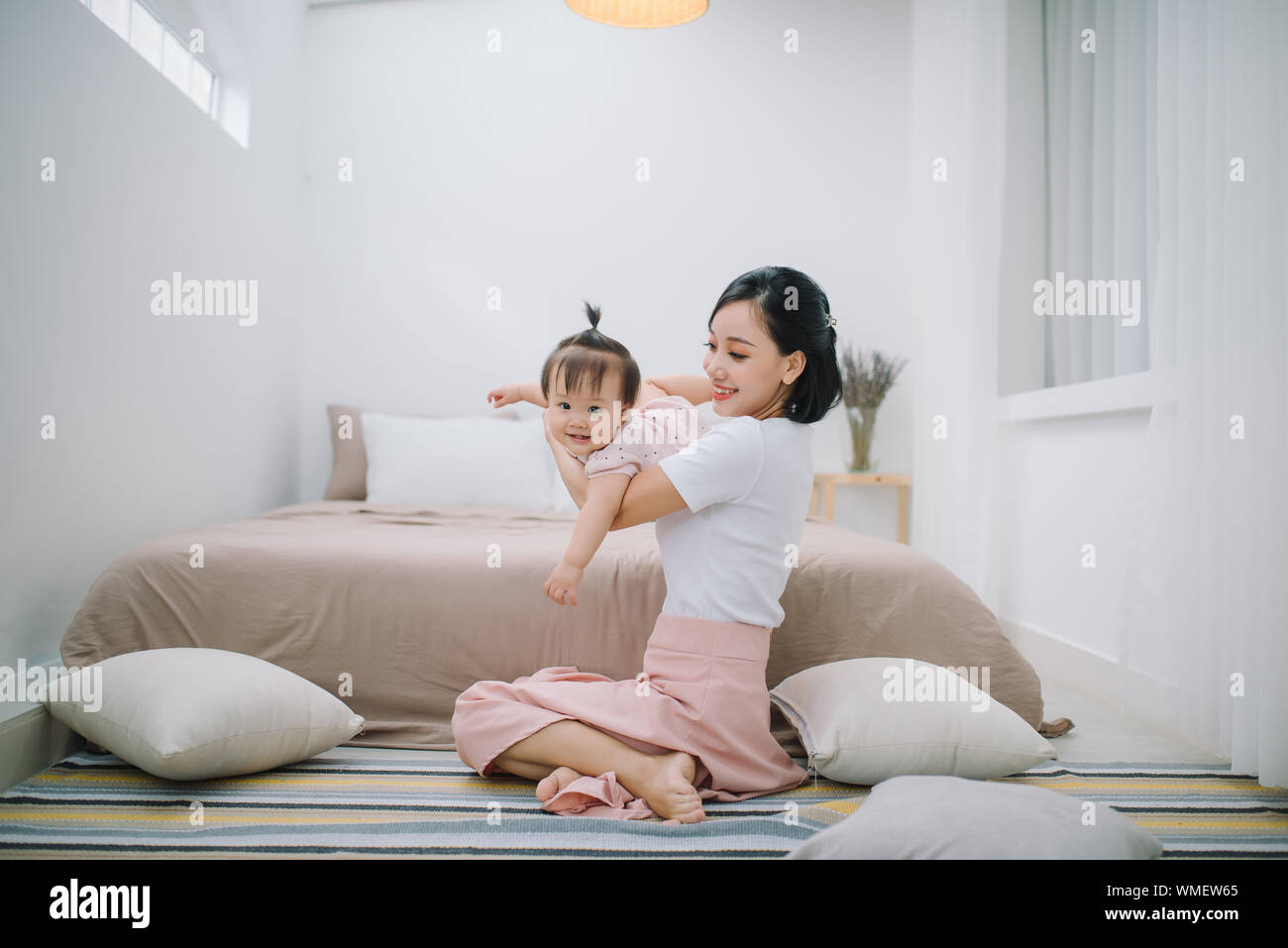 portrait of asian mother and baby relaxing in the room Stock Photo