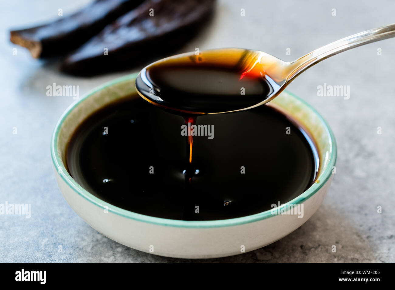 Carob Molasses Dripping from Spoon. Organic Food Stock Photo Alamy