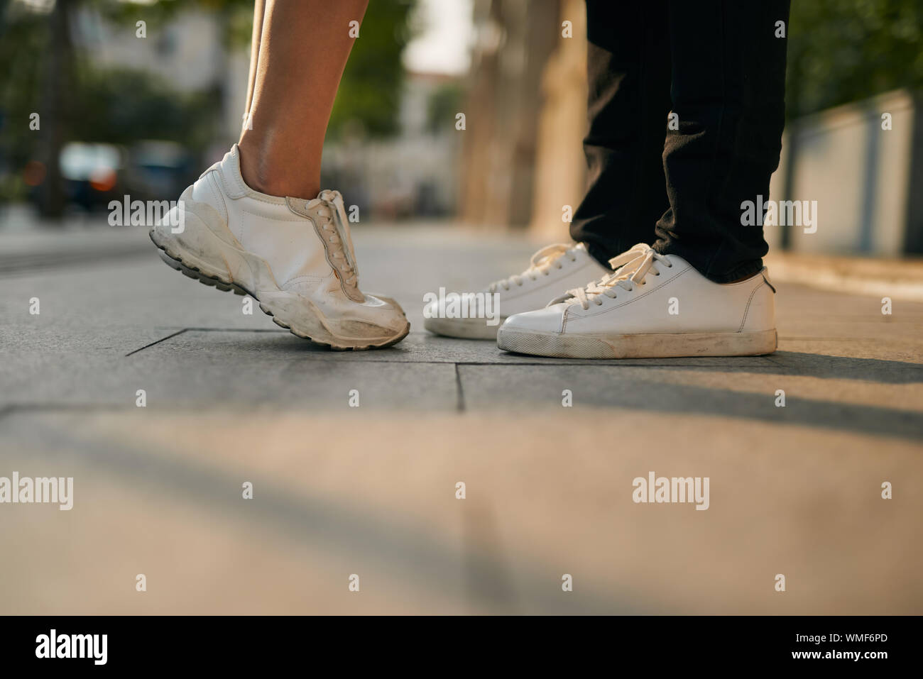 girls stands on tiptoe to kiss her man - Close up on shoes Stock Photo ...