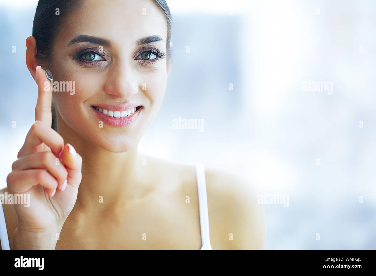 Health and Beauty. Beautiful Young Girl with Contact Lenses. Woman Holds Green Contact Lens on Her Finger. Healthy View. High Resolution Stock Photo