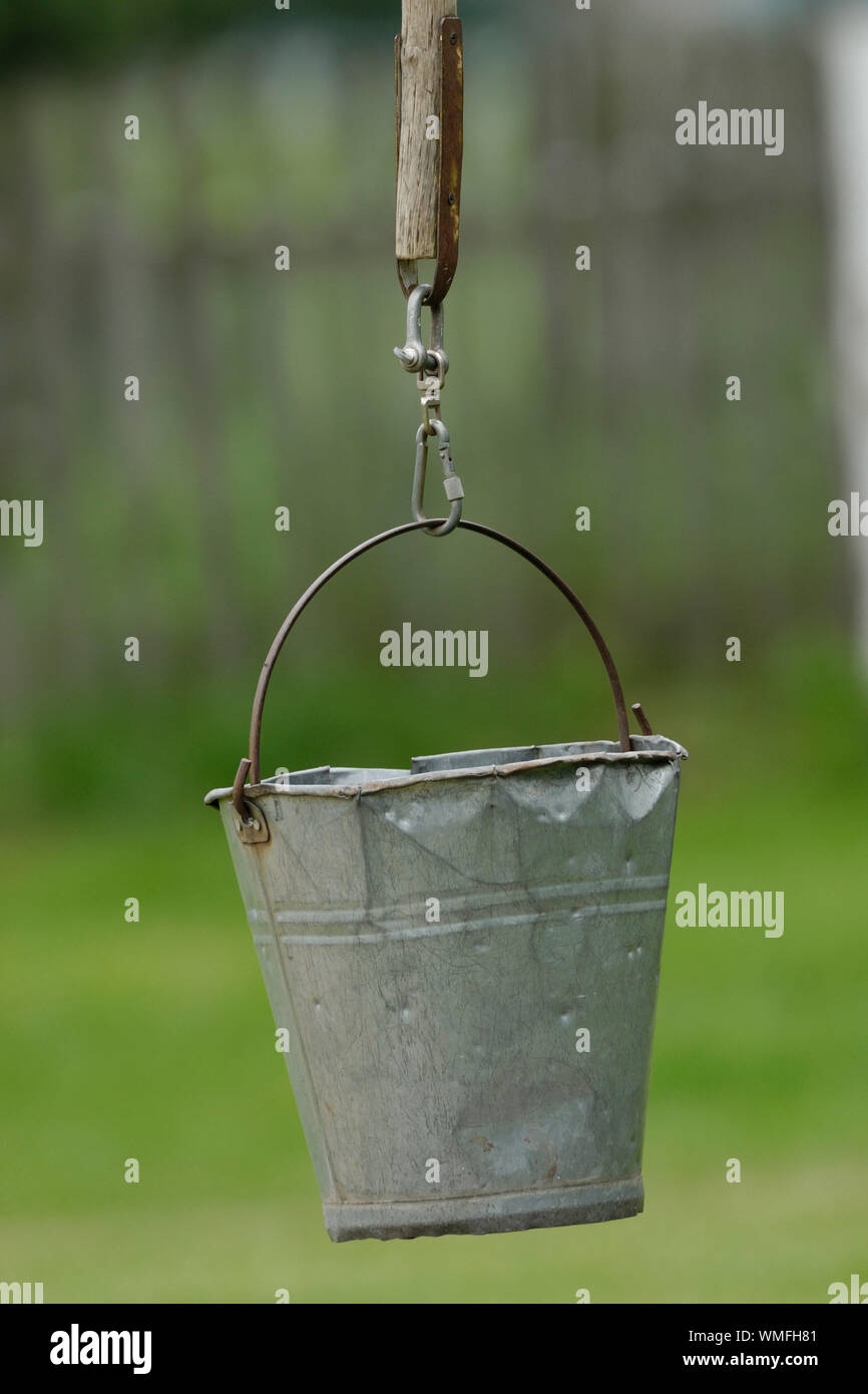 Battered metal bucket on fountain pen Stock Photo