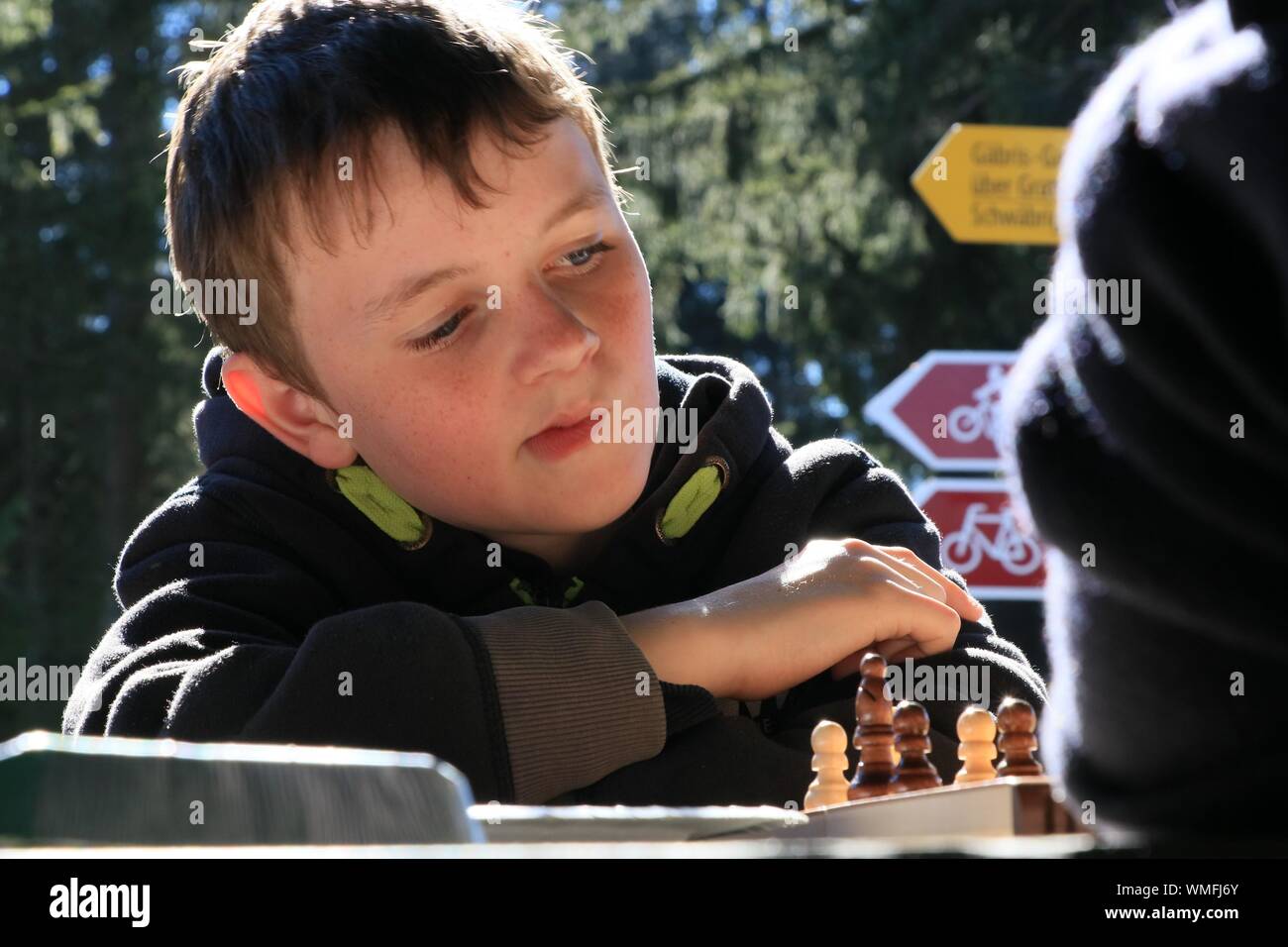 Concentrated Boy Playing Chess Stock Photo