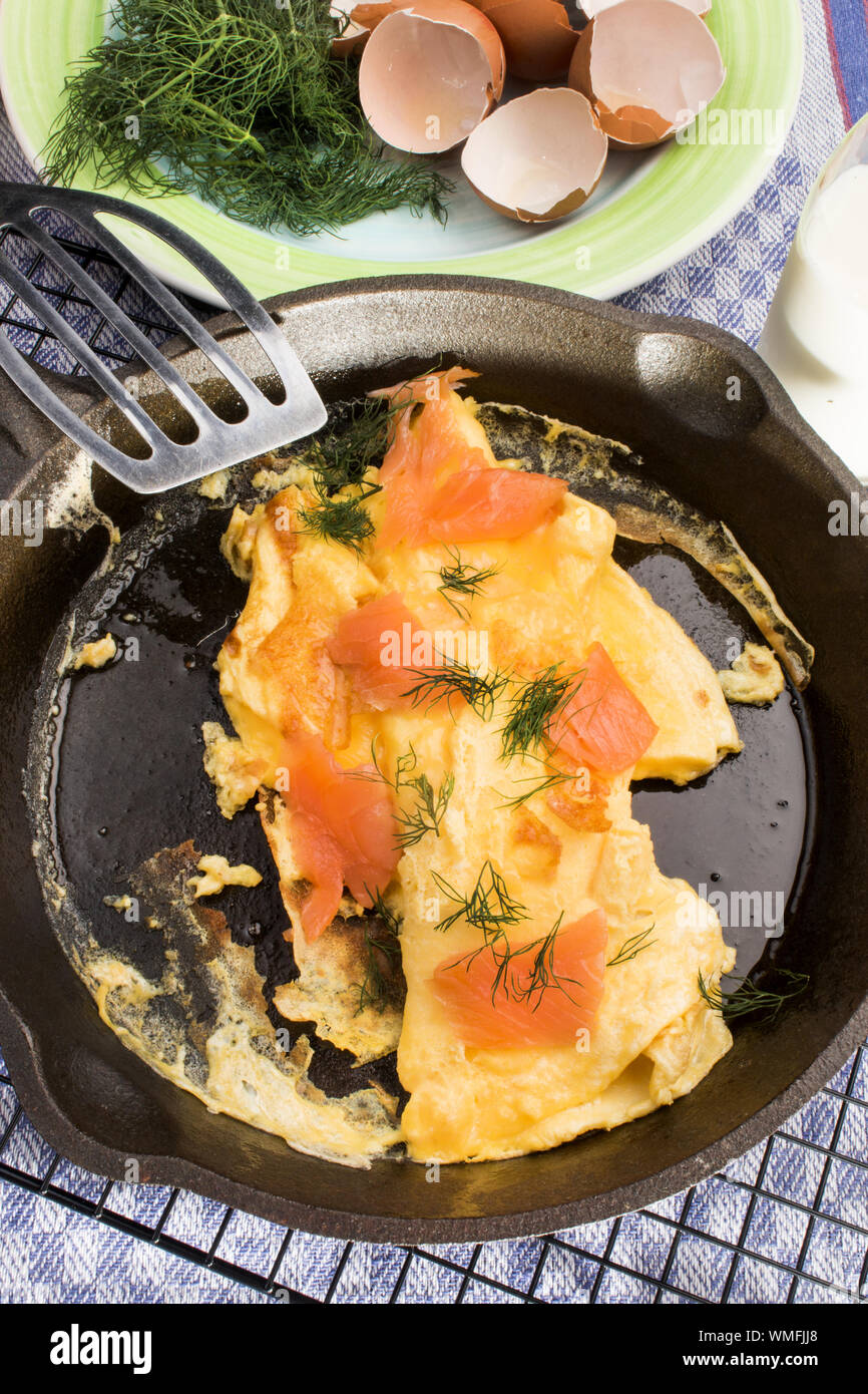 omelette with scotch smoked wild salmon in a cast iron pan Stock Photo