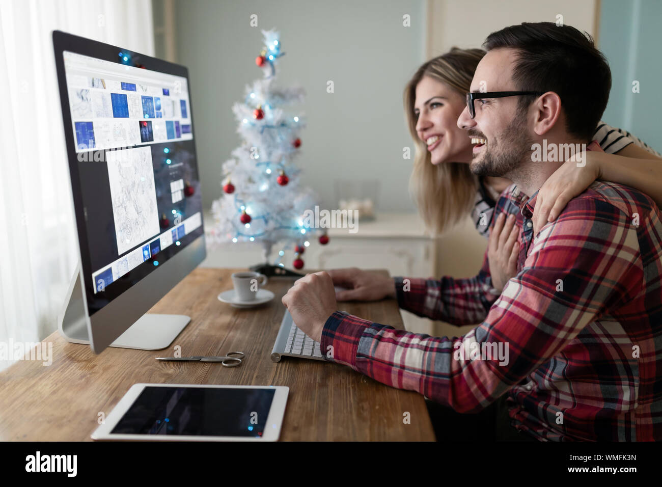 Young couple of designers working on computer Stock Photo