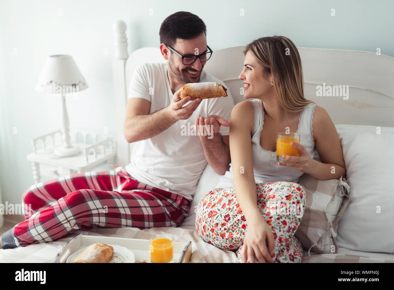 Romantic young couple having fun in bedroom Stock Photo - Alamy