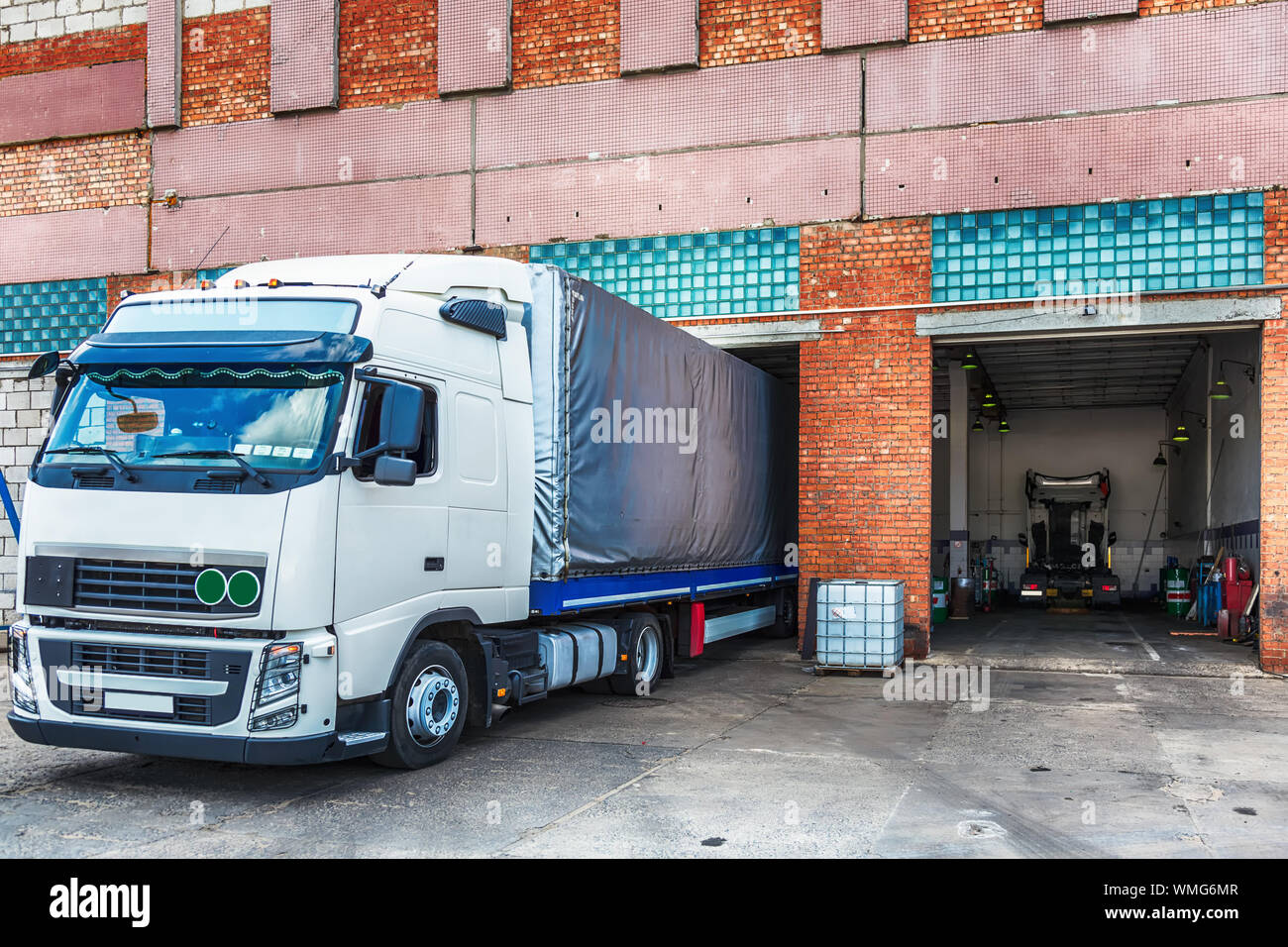 Semi-truck At Distribution Warehouse Stock Photo