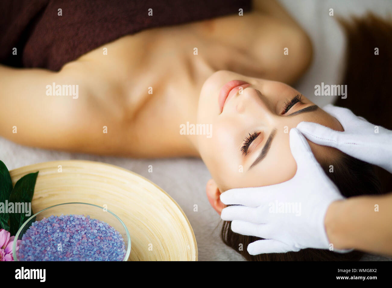 Beauty and Care. Young Woman Lying On Massage Tables In Spa Salo Stock Photo