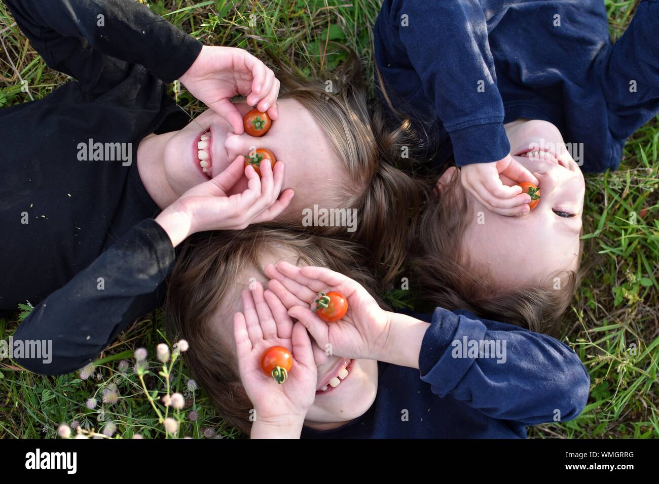 Children lying on grass hi-res stock photography and images - Alamy