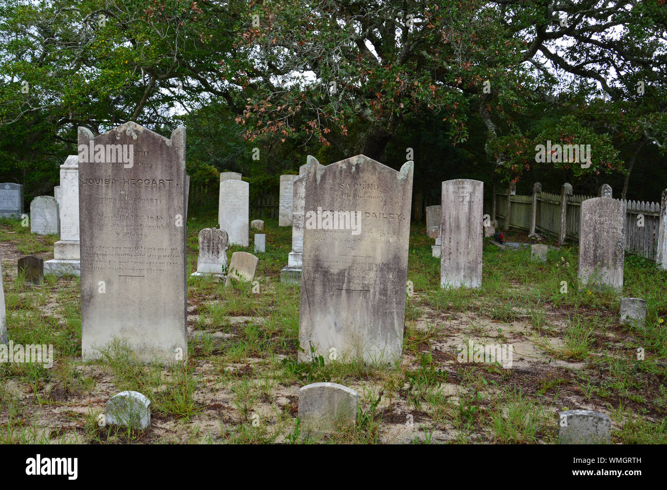 A small cemetery with weather worn head stones on Ocracoke Island in the Outer Banks of North Carolina. Stock Photo