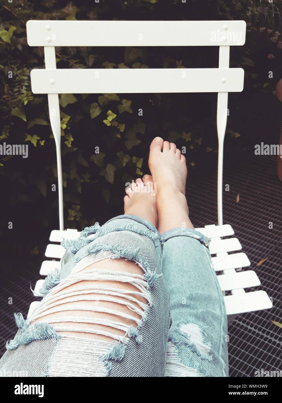 Sitting in chair barefoot hi-res stock photography and images - Alamy