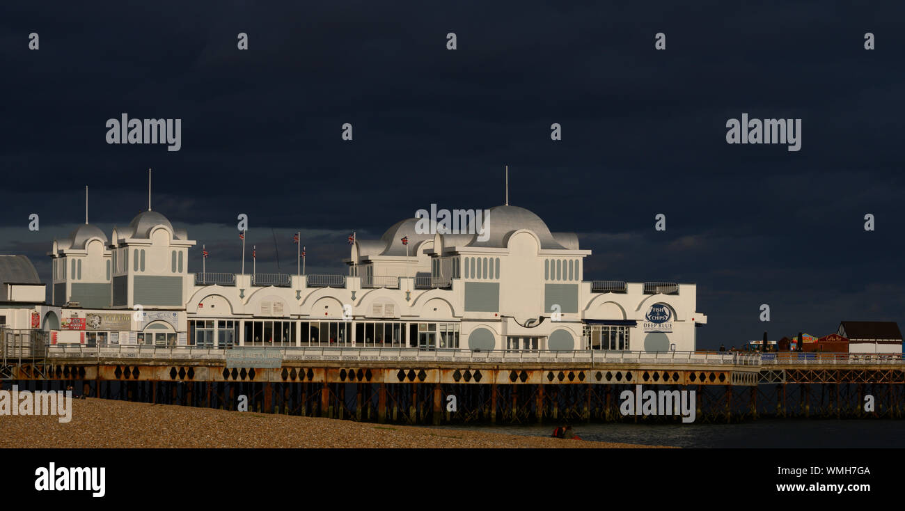 Dramatic evening light illuminates South Parade Pier, Southsea, Portsmouth, Hampshire, England, UK Stock Photo