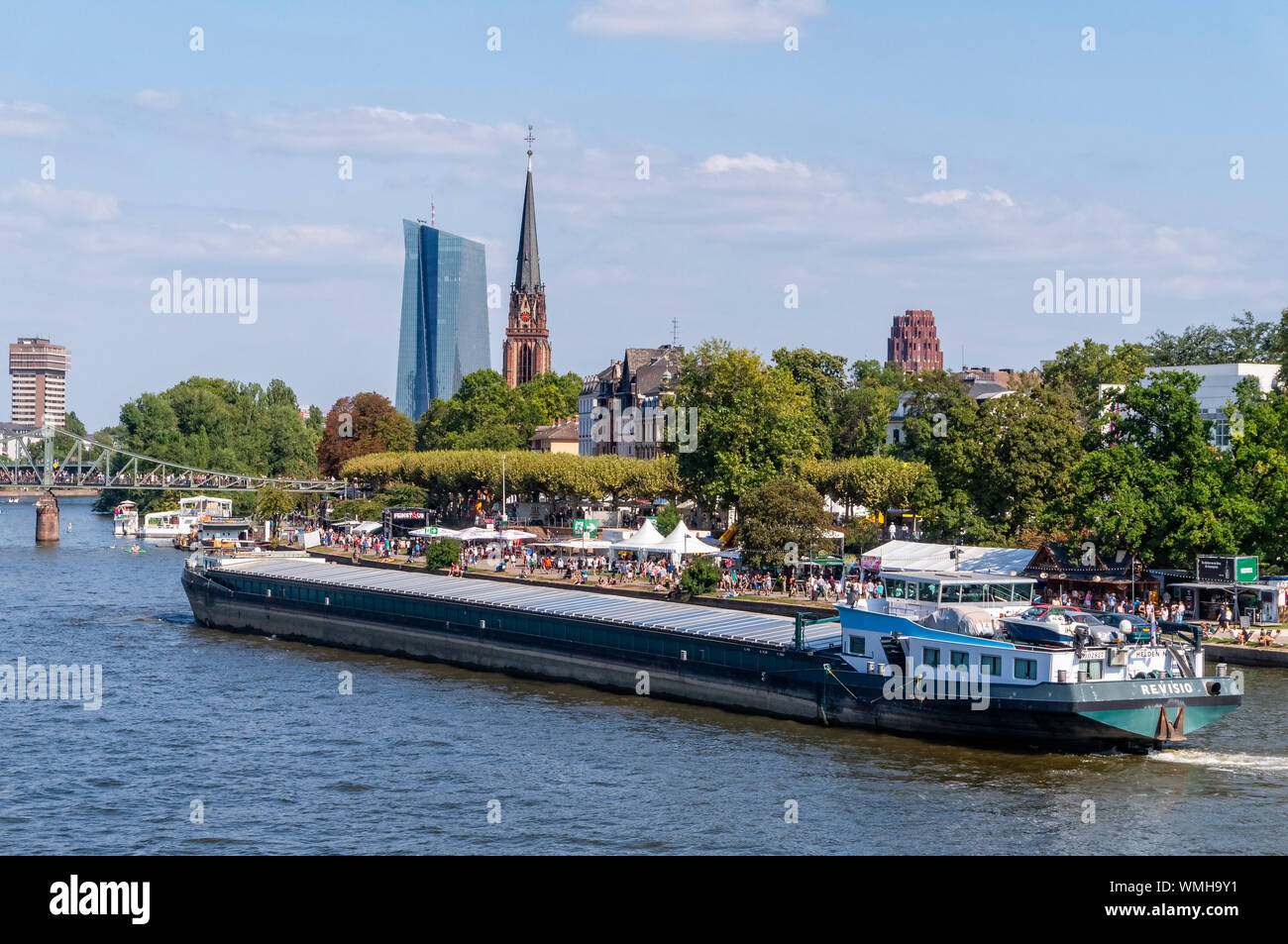 A cargo ship travels on the Main in Frankfurt with the European Central Bank (ECB) in the background Stock Photo