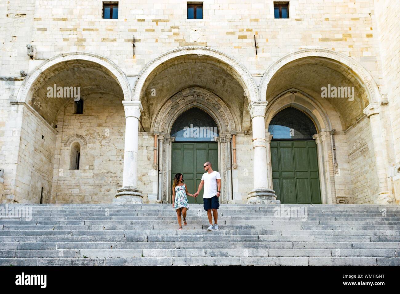Low Angle View Of Heterosexual Couple Standing On Stairs Stock Photo