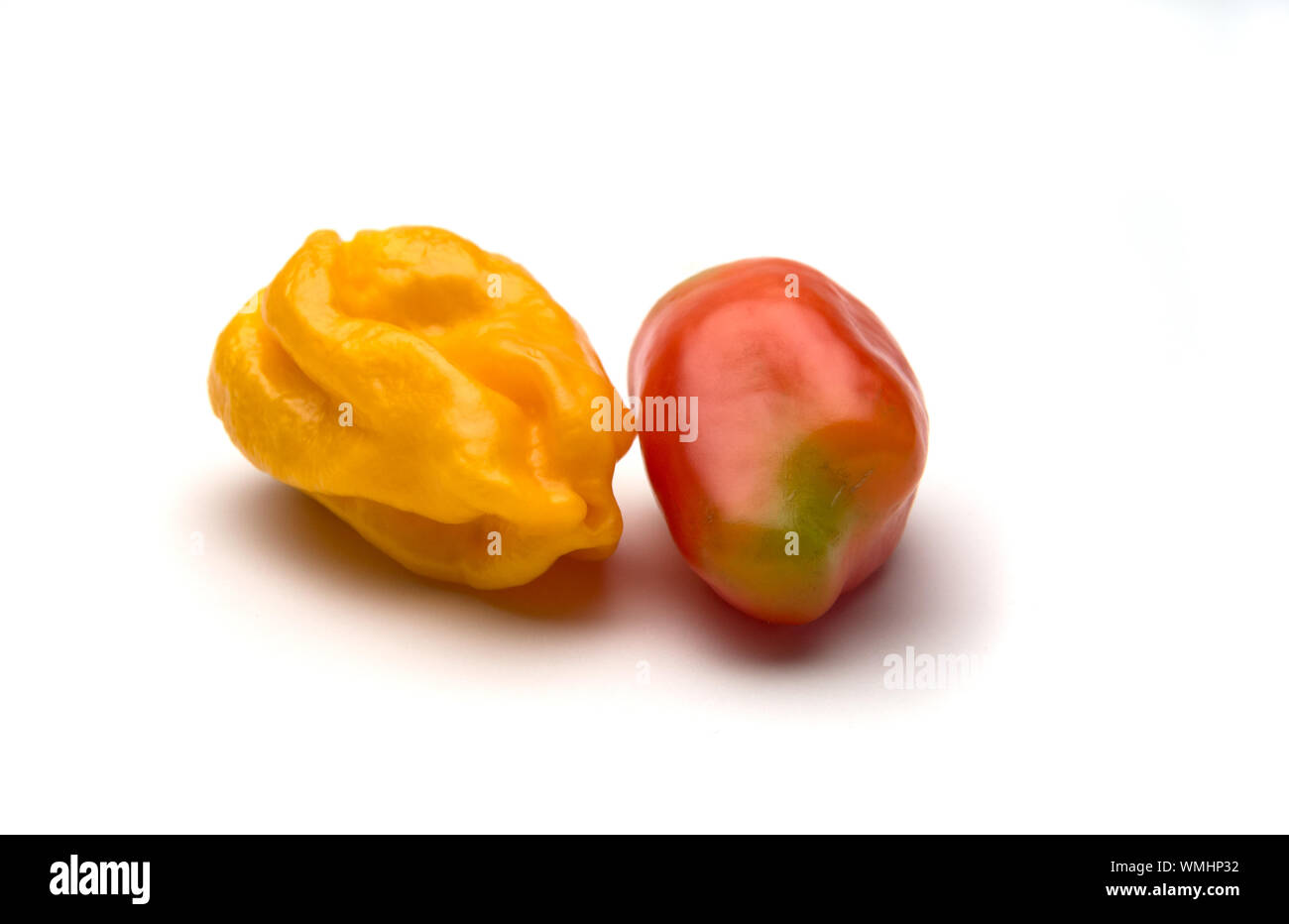 One yellow ripe  pepper and one  red ripe pepper isolated on white background. Selective focus. Stock Photo