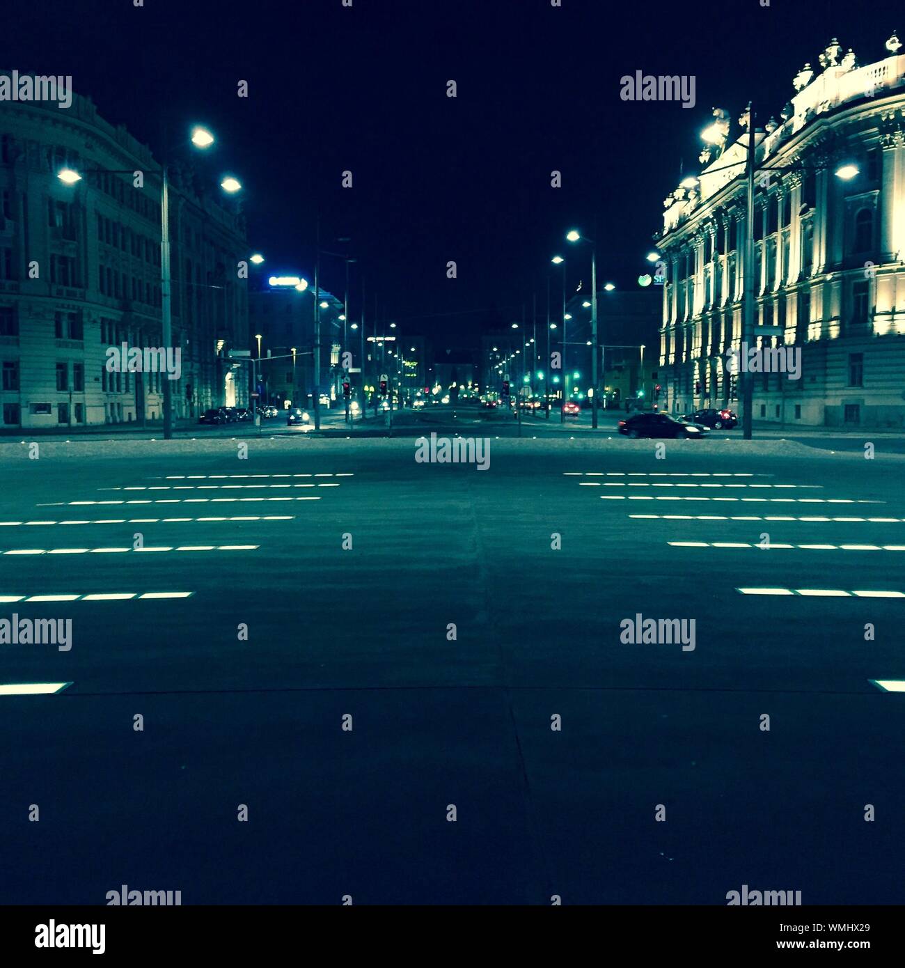 Pedestrian Crossings On Road In City At Night Stock Photo