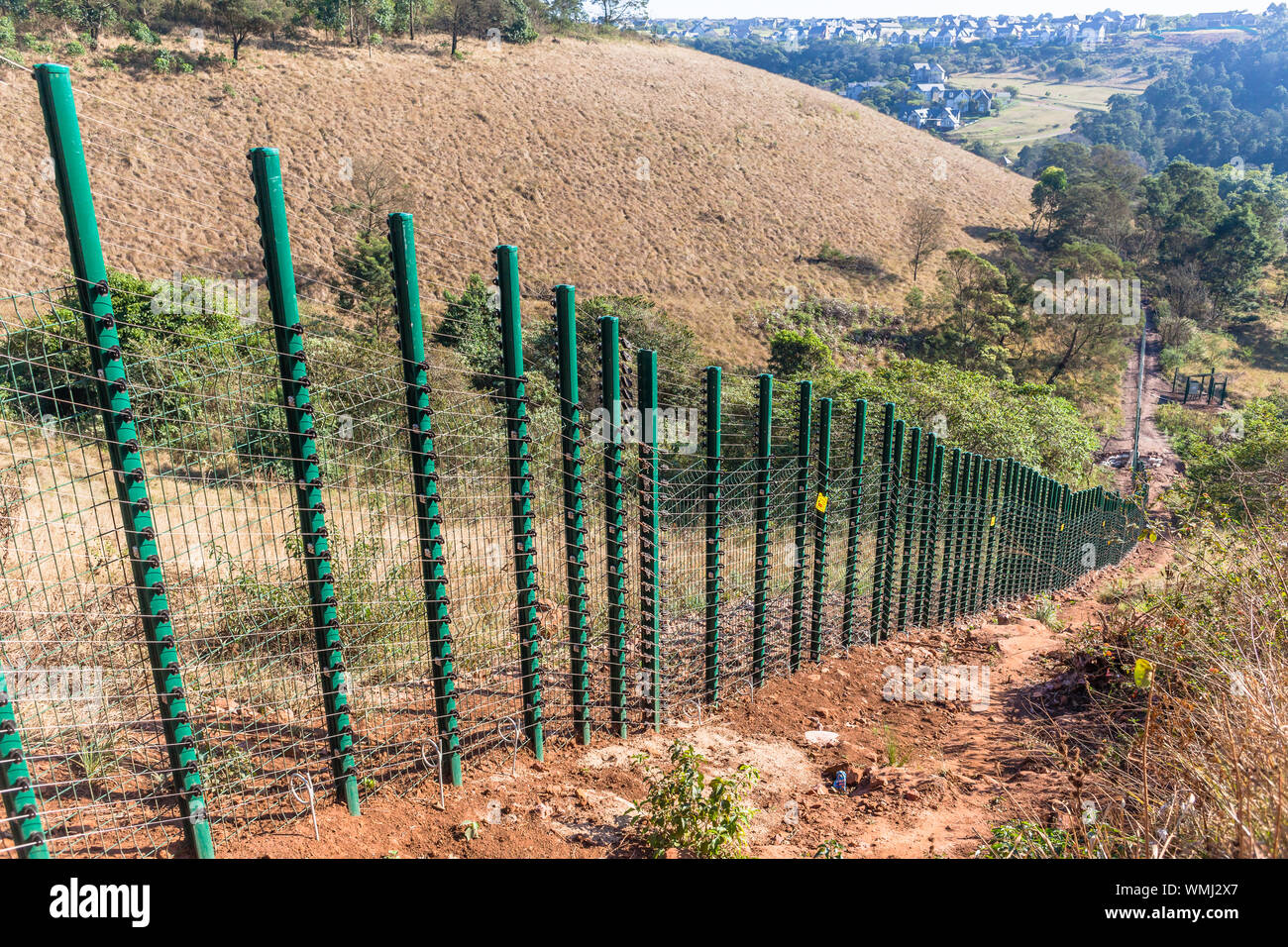 New Security electrified fence constructed in rural countryside valley landscape Stock Photo