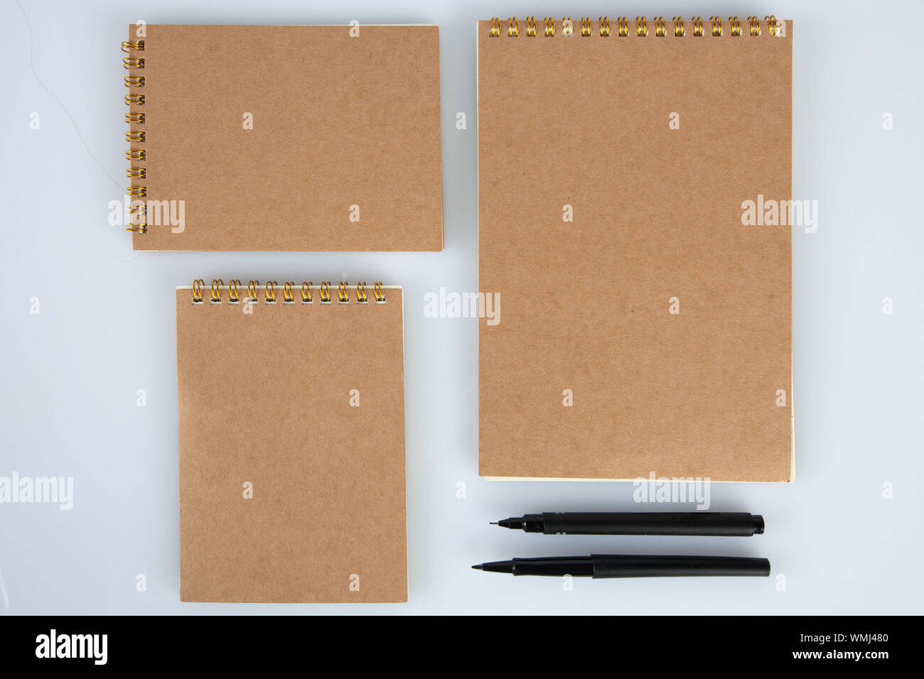 Directly Above Shot Of Notepads With Pens Over White Background Stock Photo
