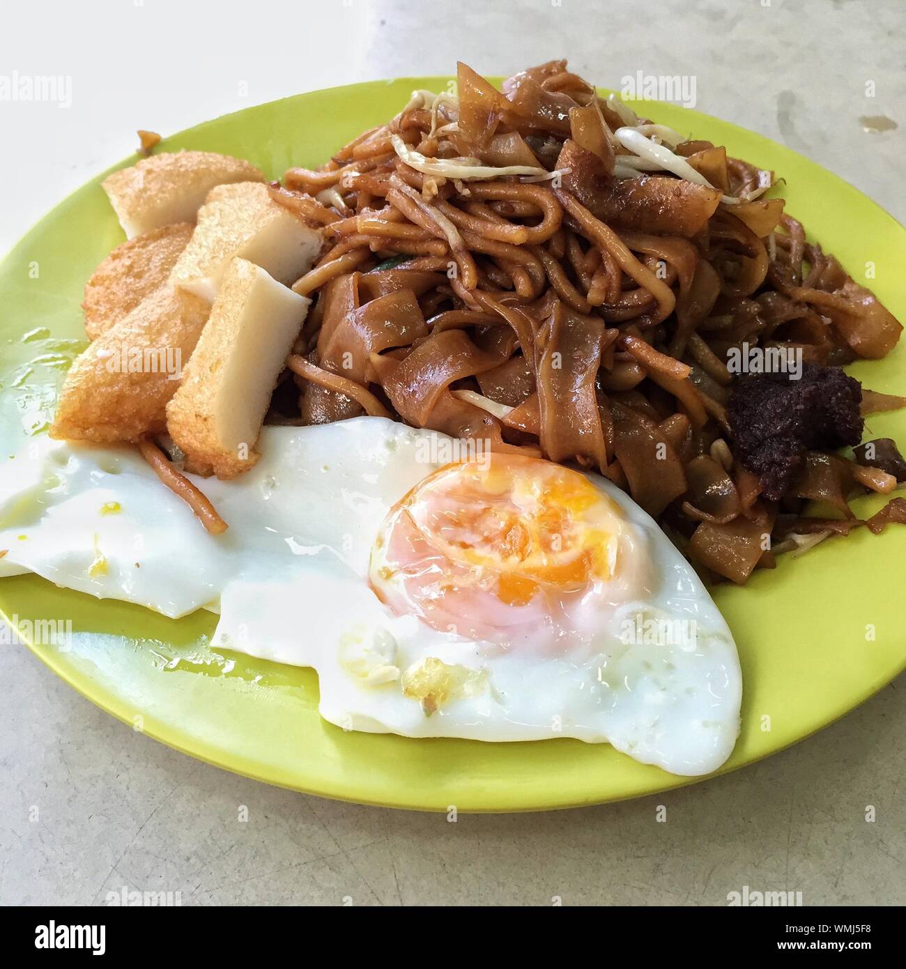 Close Up View Of Ready-to-eat Meal With Fried Egg Stock Photo