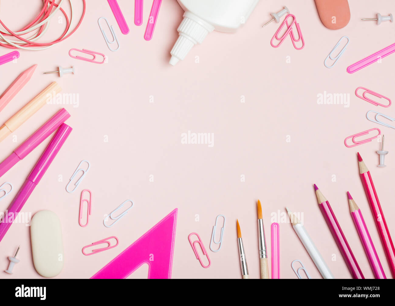 School supplies of pink and white colors on a pink background