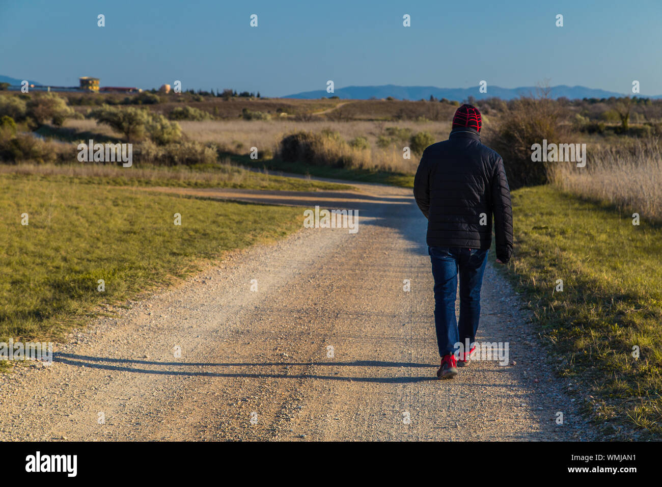 Man walking on country road hi-res stock photography and images - Alamy