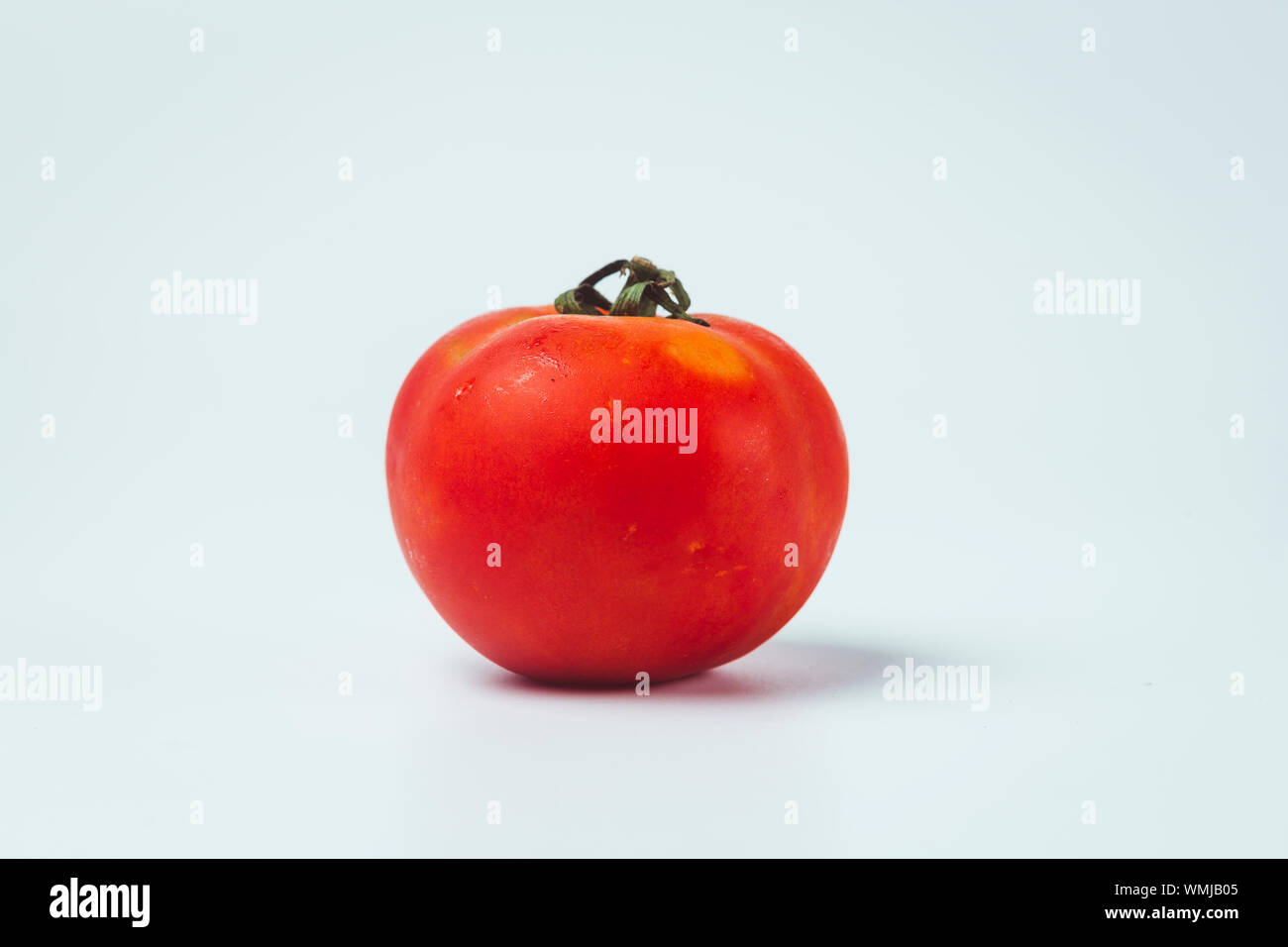 Tomato isolated. Tomato with clipping path. Full depth of field. Stock Photo