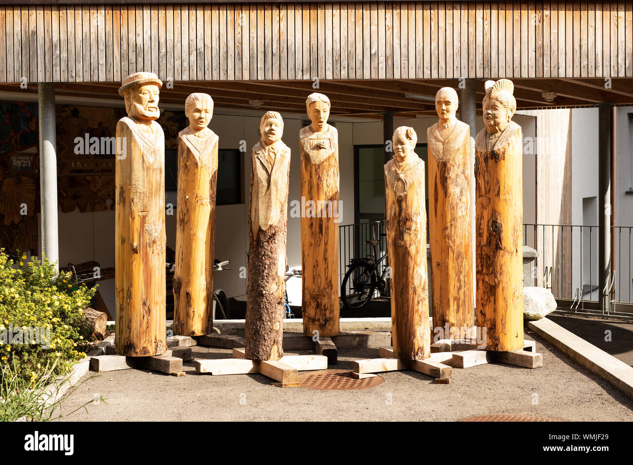 A display of wooden figures outside the Schule für Holzbildhauerei (wood carving school) on