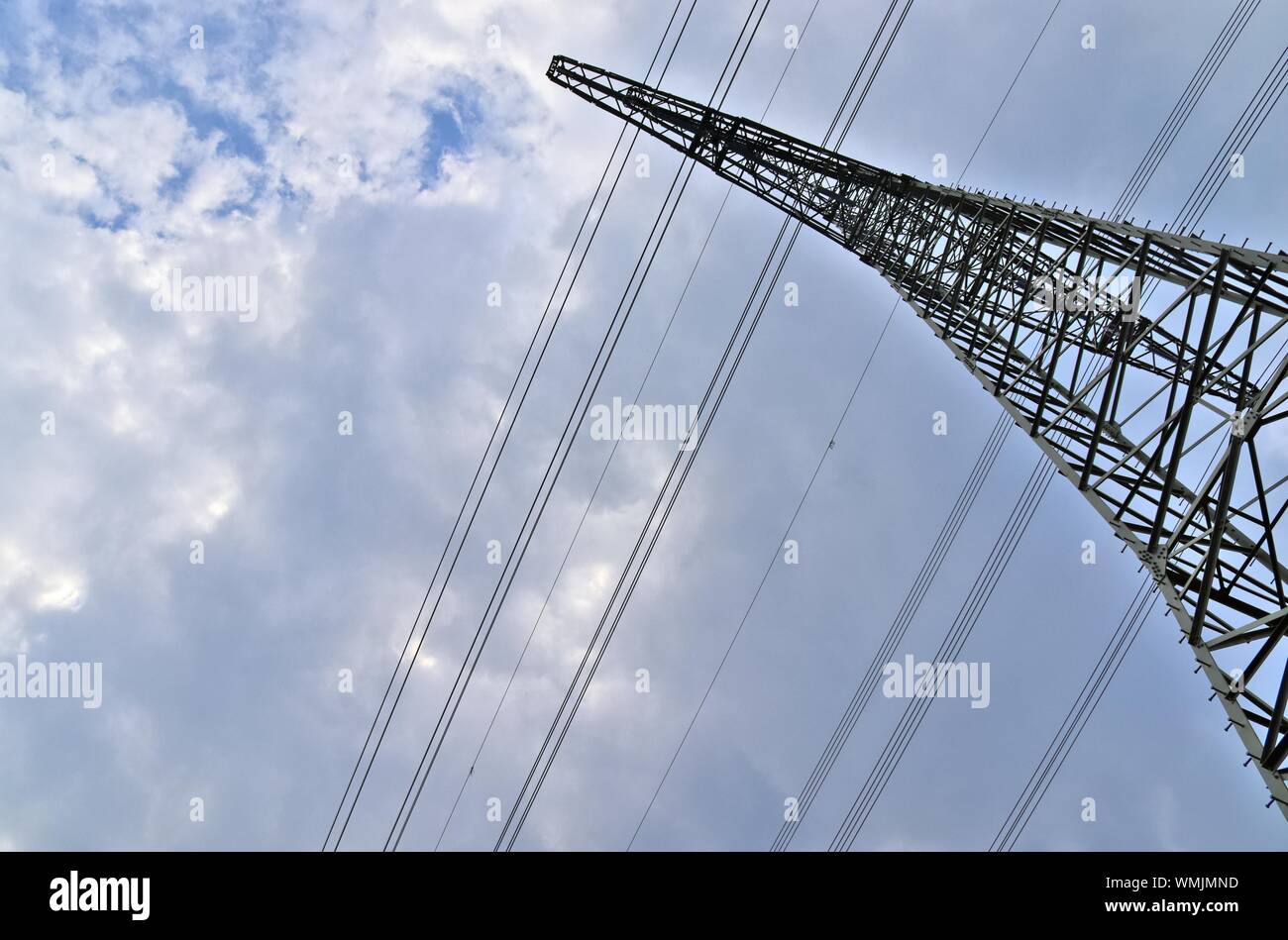 Close up view on a steel power pylon with high voltage power lines ...