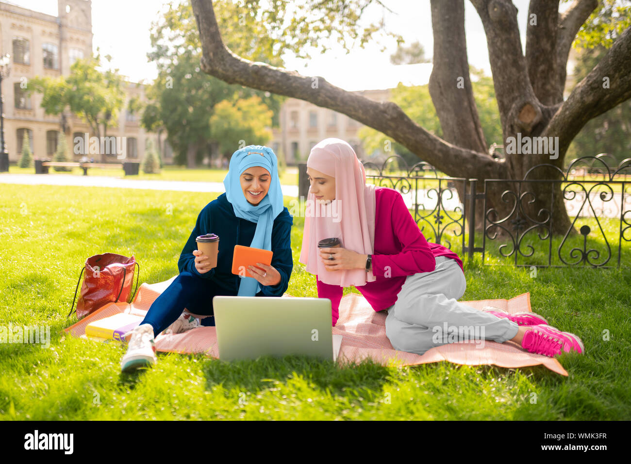 Two female muslim students enjoying coffee break Stock Photo
