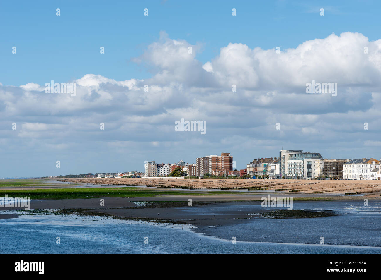 Worthing seafront during low tide on a sunny day looking along the