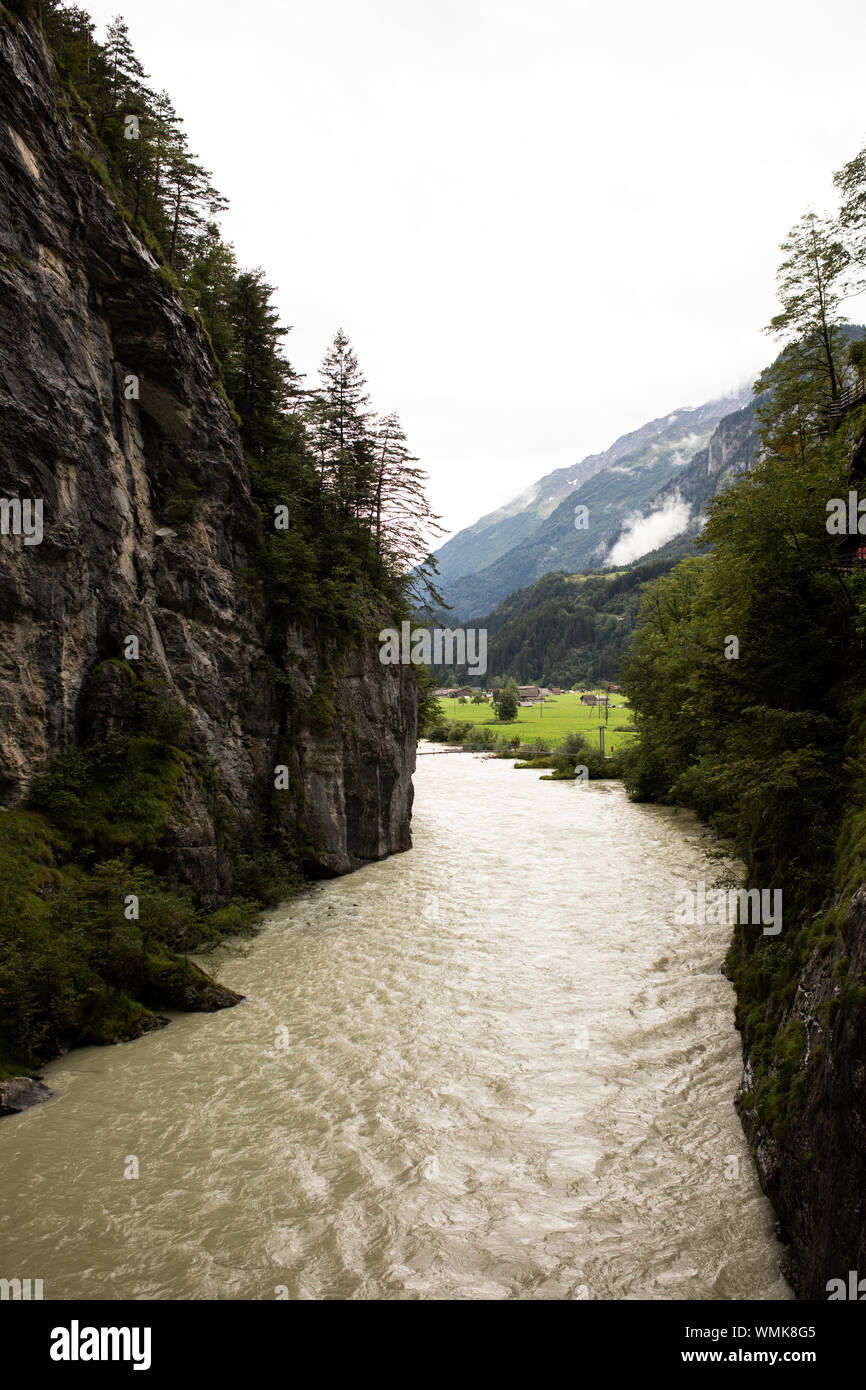 The Aare River rushes through a chasm carved from limestone at the end of the Ice Age at the Aare Gorge in Meiringen, Bernese Oberland, Switzerland. Stock Photo