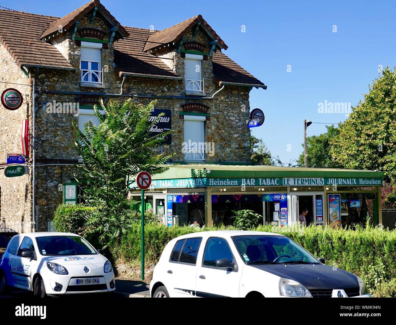 Le Terminus, a small tabac across from the train station that serves as a bar, news shop, and gathering place for many locals in Andrésy, France. Stock Photo