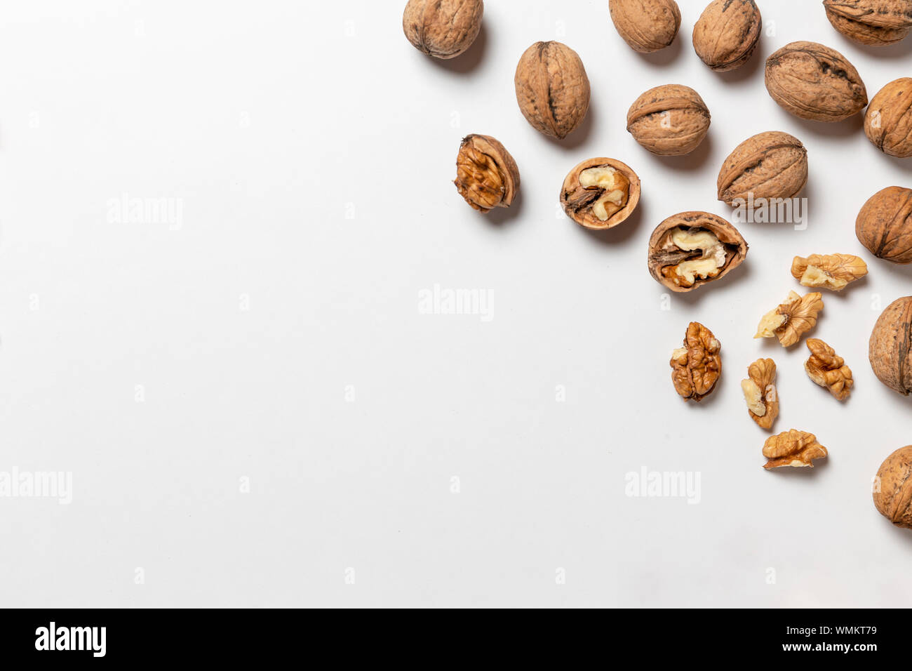 Group of walnuts and peeled walnuts on a white Stock Photo Alamy