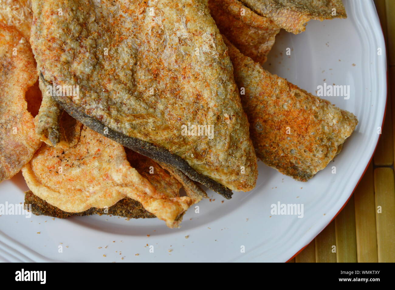 crispy fried fish skin with seasoning on dish Stock Photo Alamy