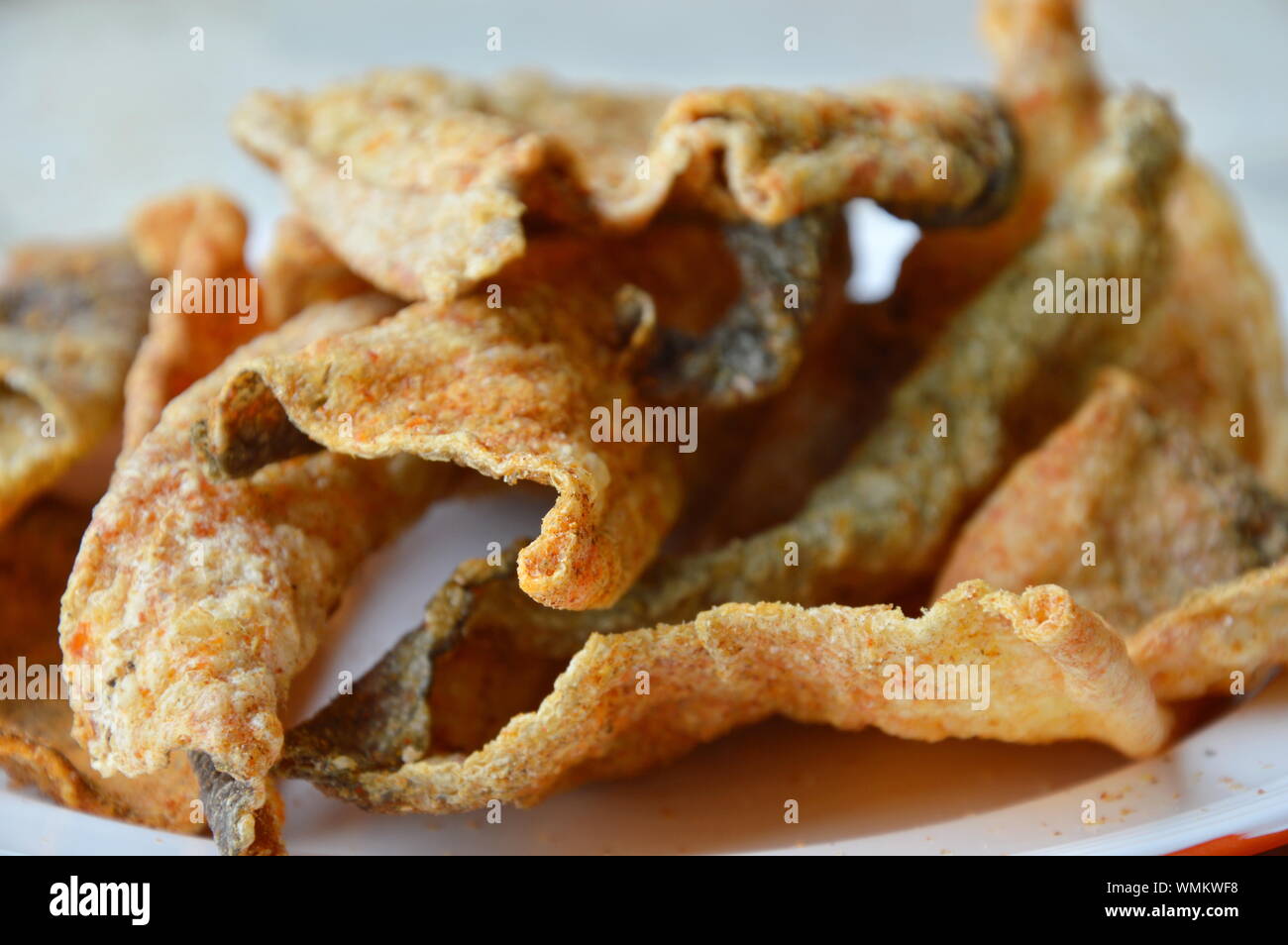 crispy fried fish skin with seasoning on dish Stock Photo Alamy