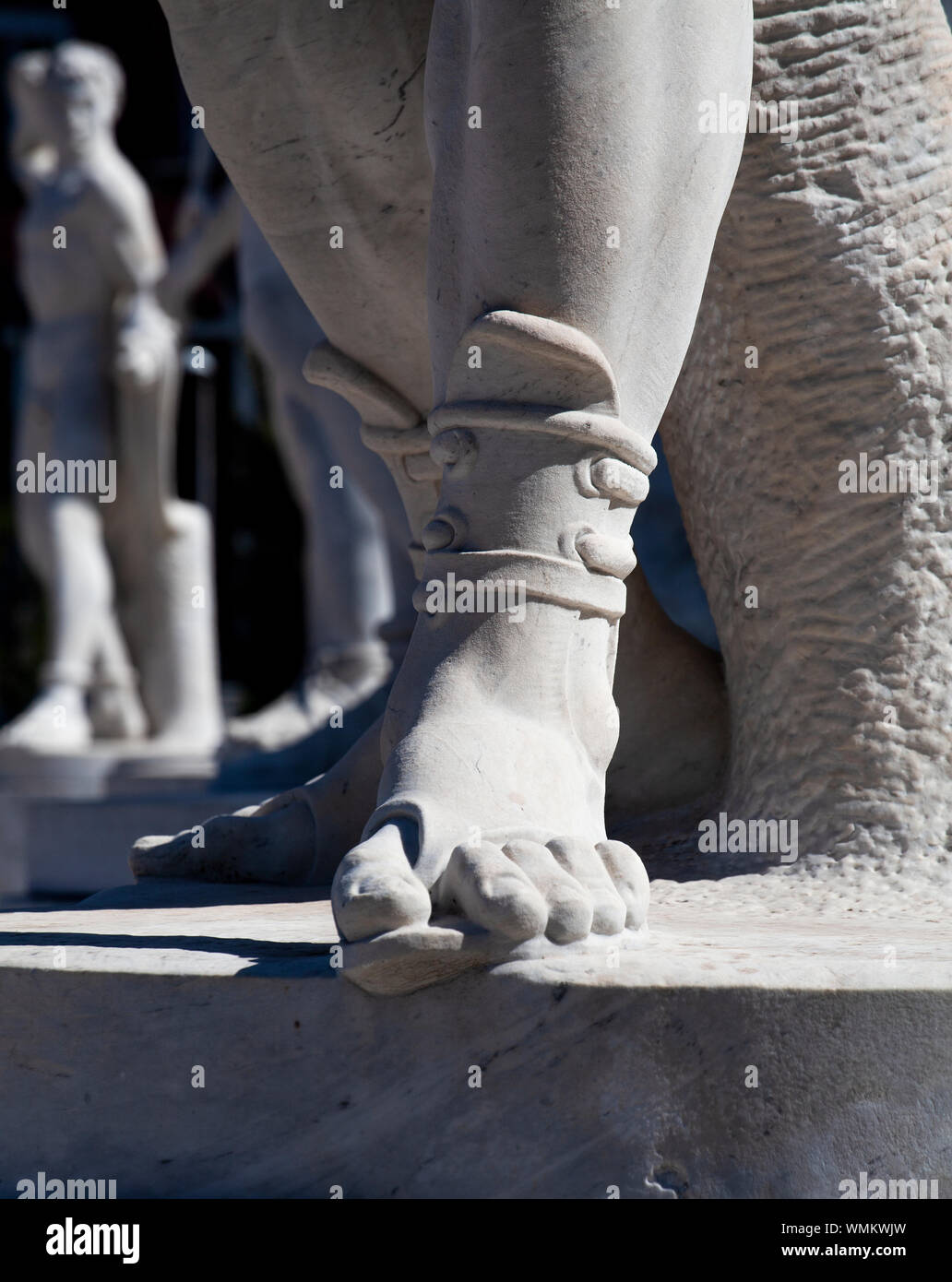 A detail of a statue in the Stadio dei Marmi in Rome showing the foot ...