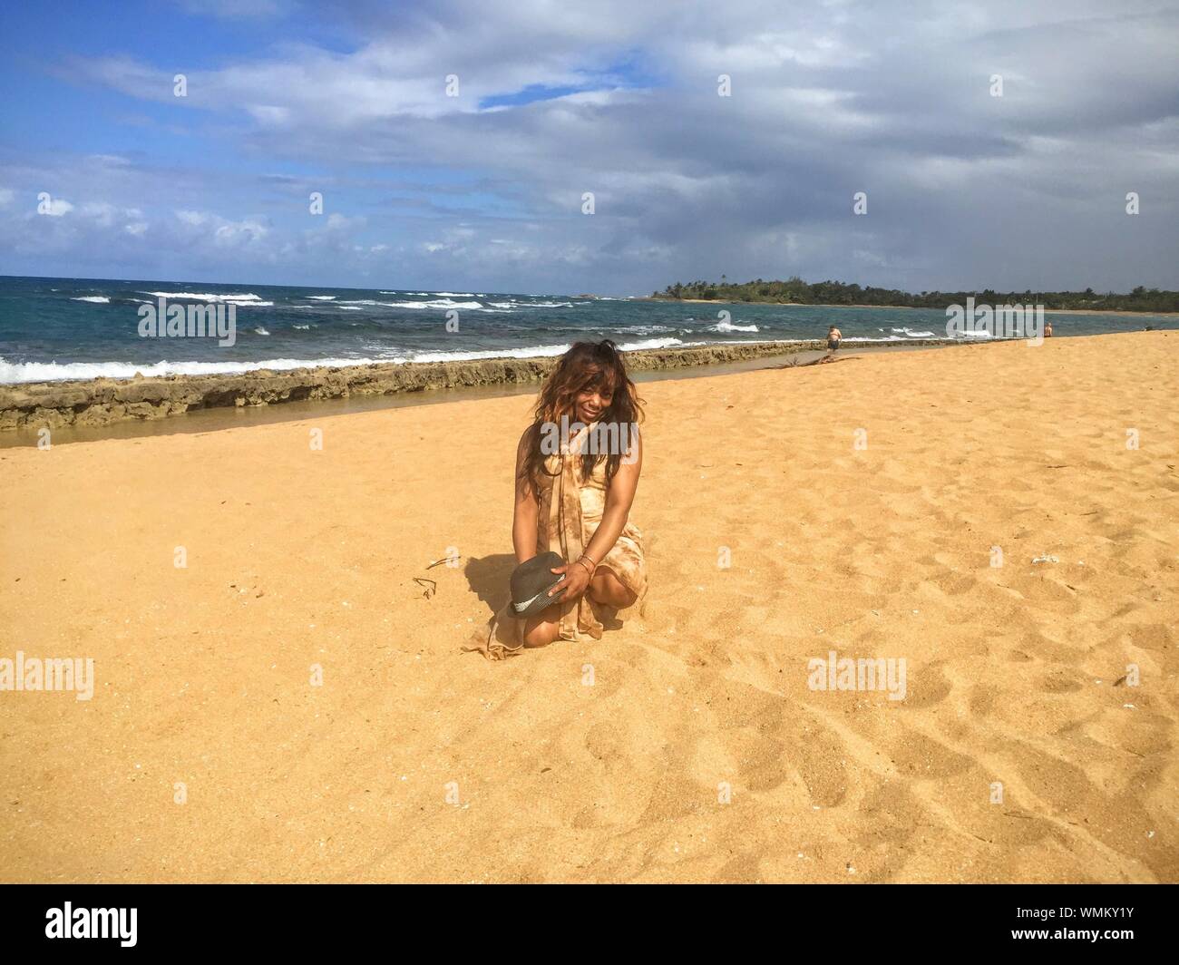 Portrait woman kneeling on beach hi-res stock photography and images ...