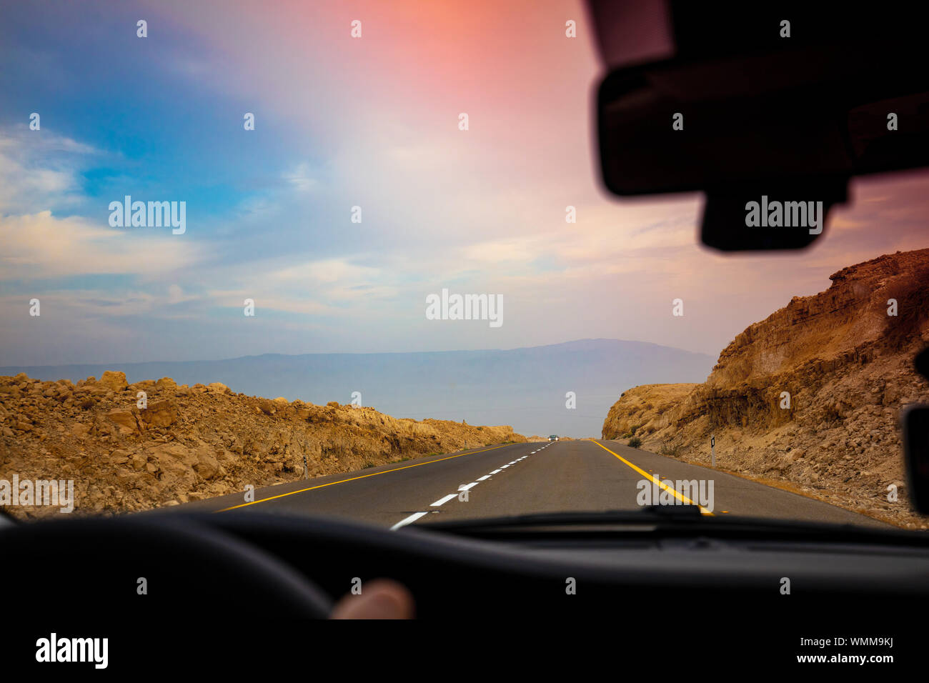 Driving a car on the mountain road in the desert. View of sandstone ...