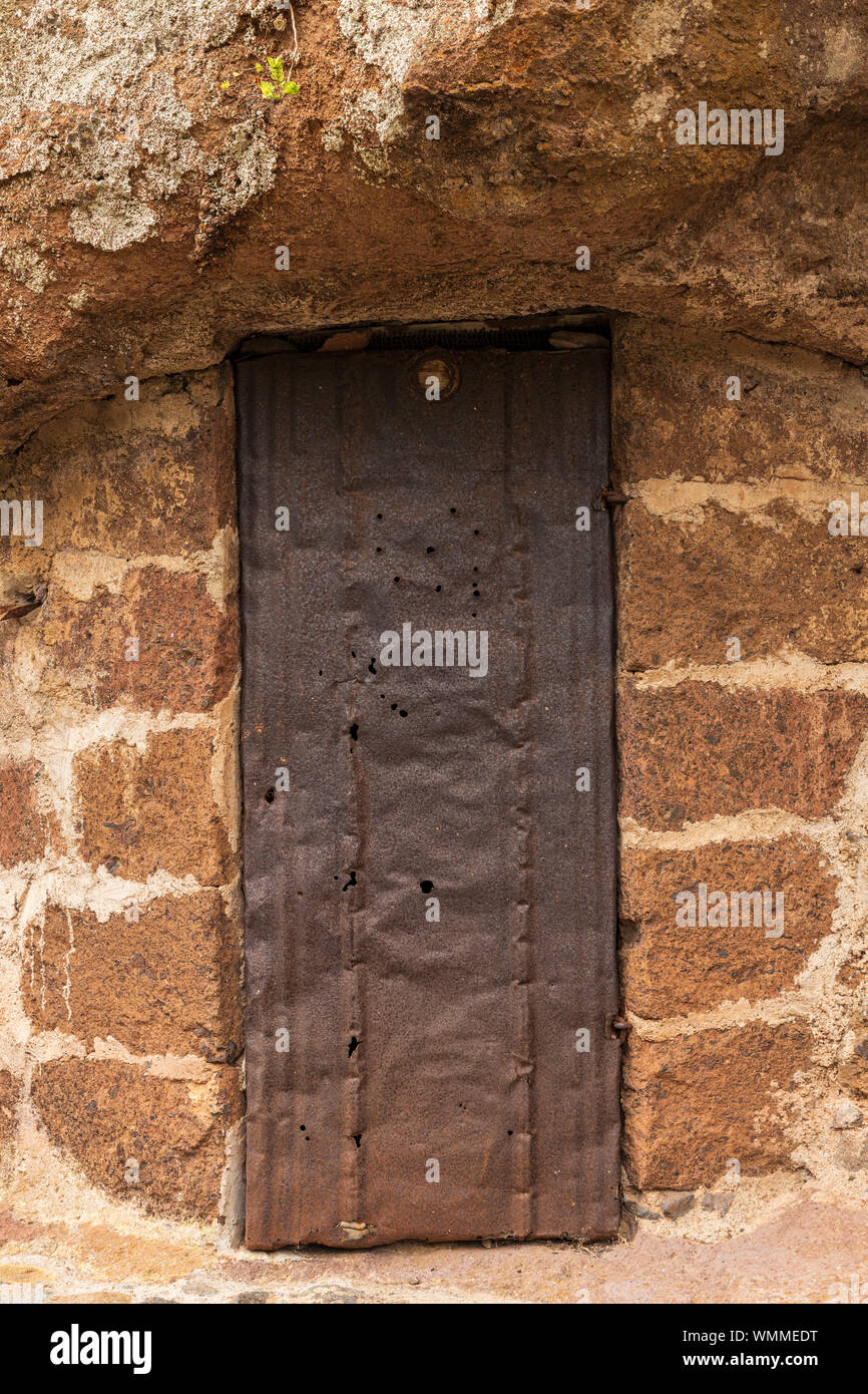 Old cave dwelling with rusted metal door, storage room in barranco seco, Anaga, Tenerife, Canary Islands, Spain Stock Photo