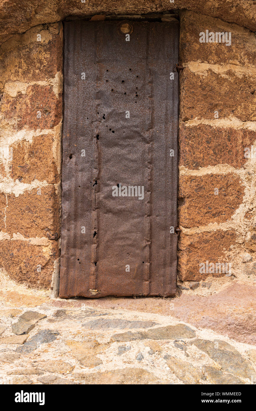 Old cave dwelling with rusted metal door, storage room in barranco seco, Anaga, Tenerife, Canary Islands, Spain Stock Photo