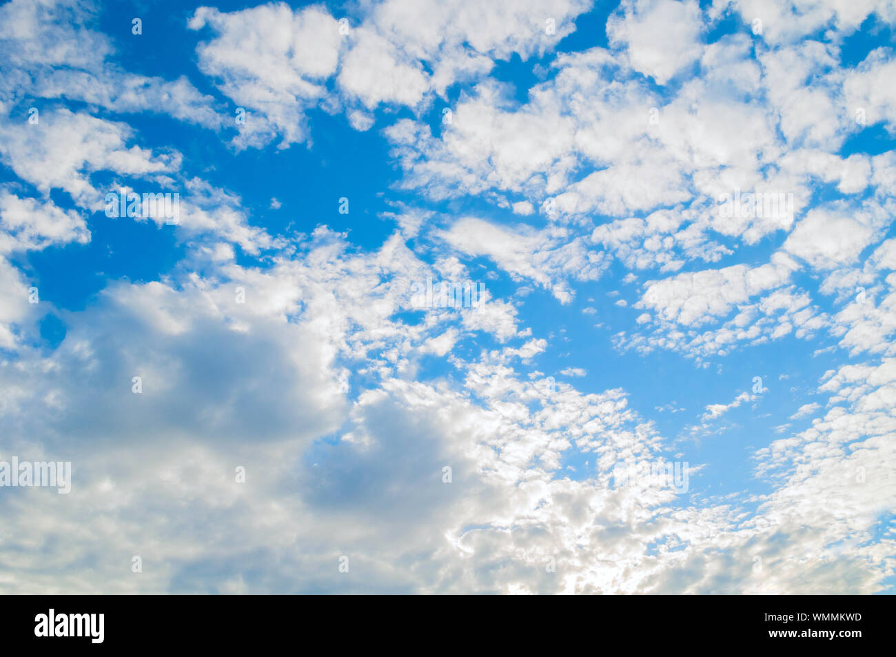 Dramatic blue sky background - picturesque colorful clouds lit by