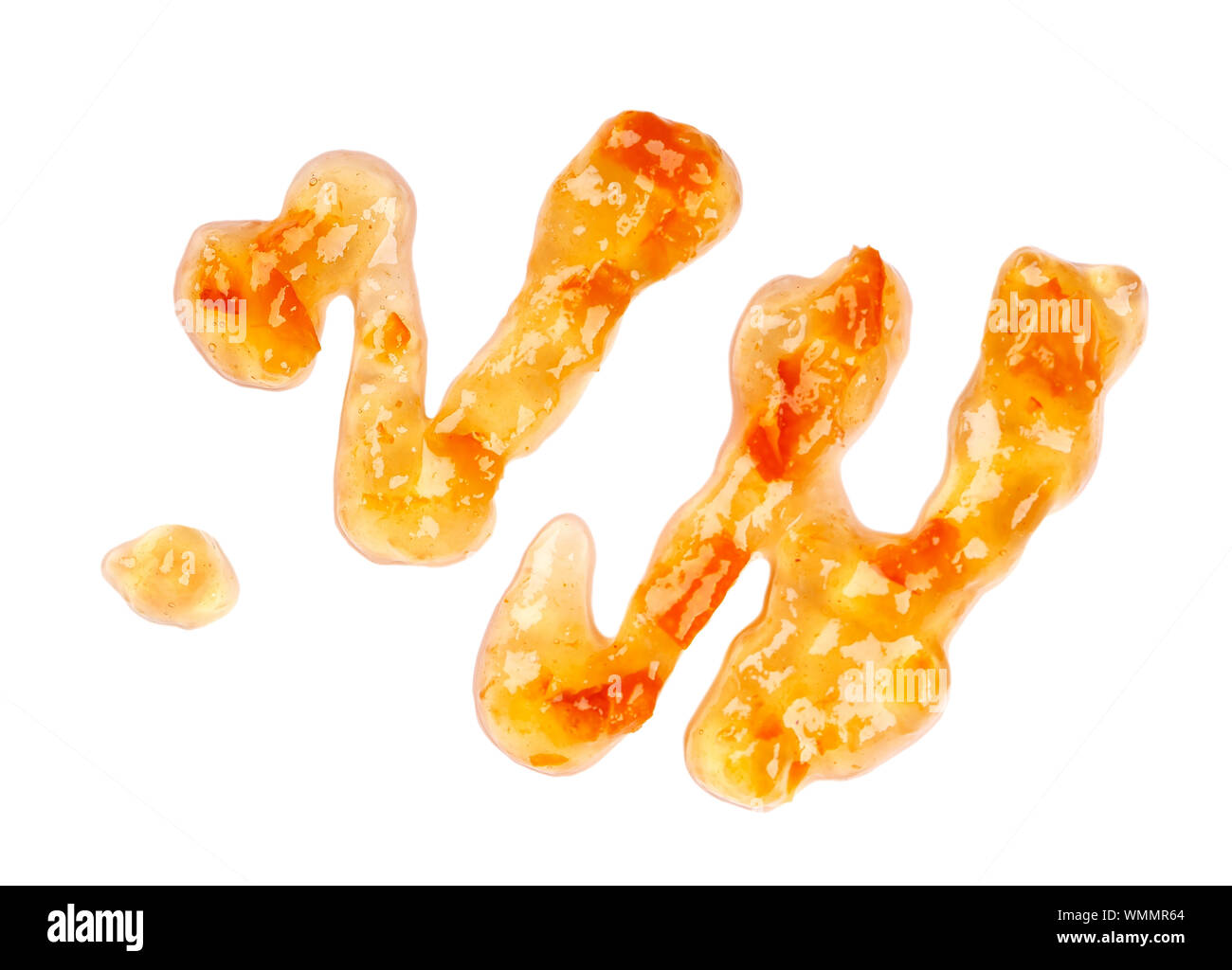 Orange thick jam drizzle, isolated on white background. Mandarin marmalade, sauce, topping drops. Top view. Stock Photo