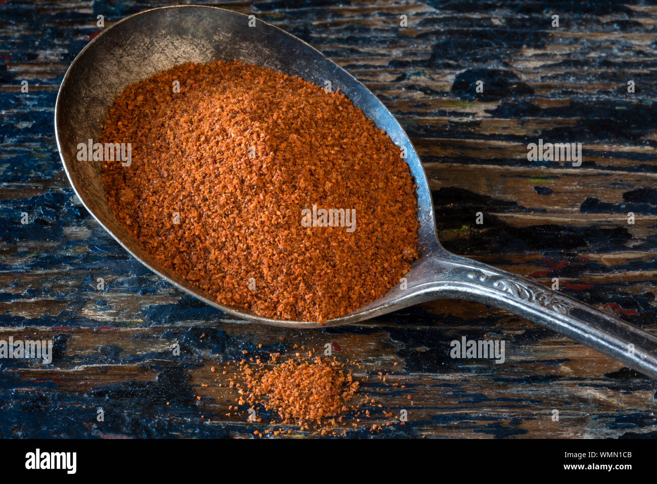 Close-up Of Grounded Cayenne In Spoon On Table Stock Photo