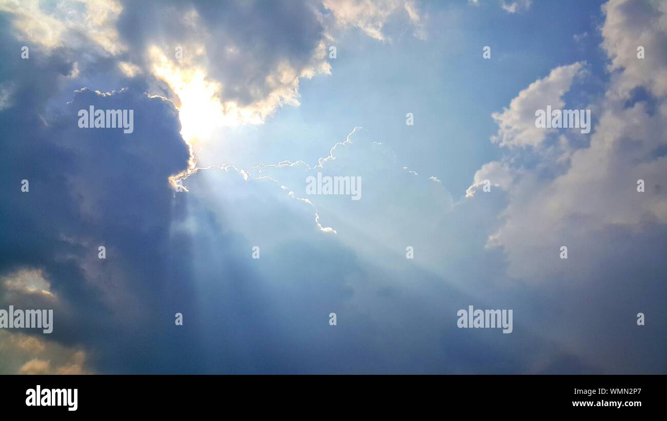 Sun Behind Clouds Stock Photo - Alamy