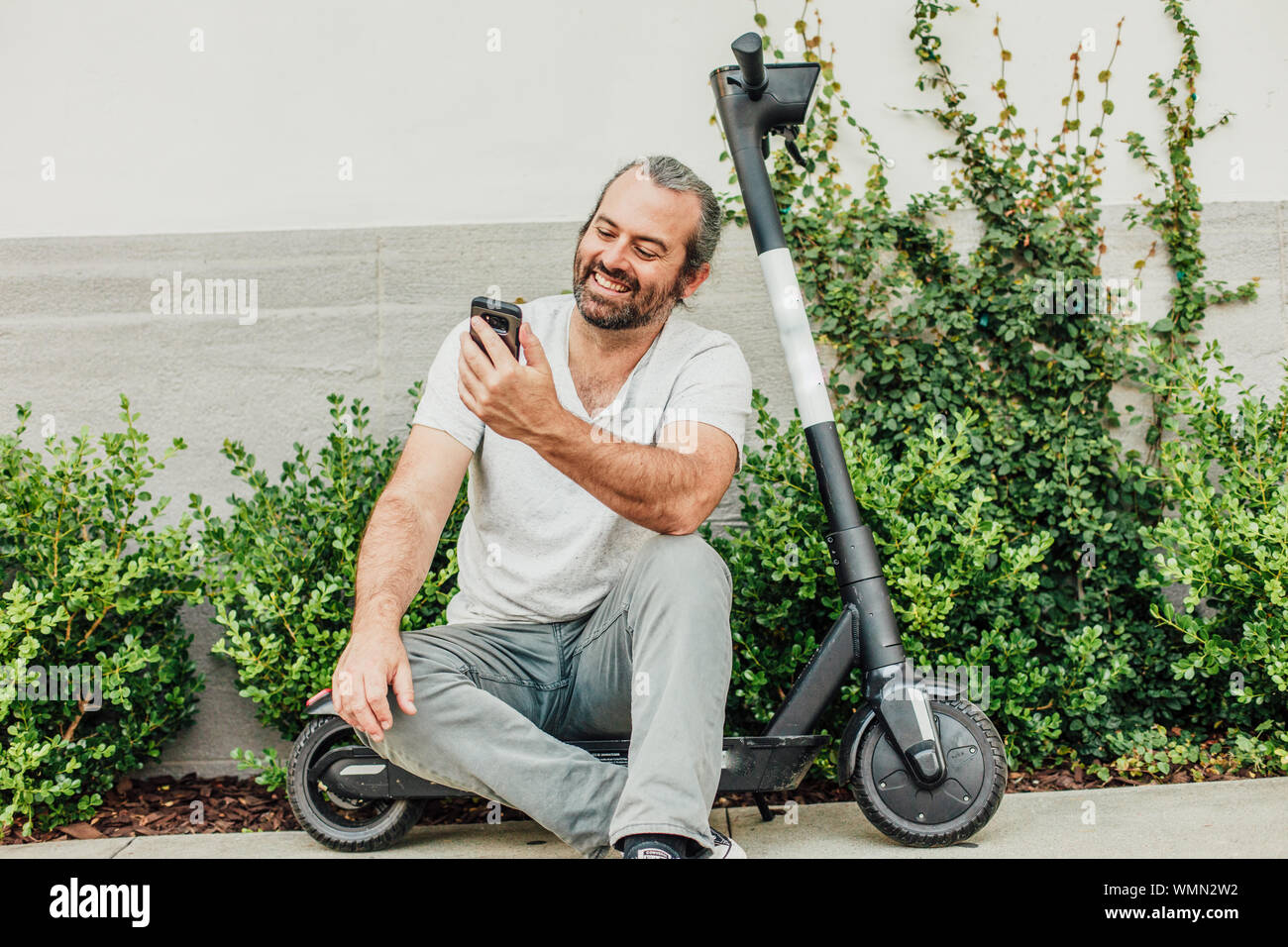 Man sitting on scooter hi-res stock photography and images - Alamy