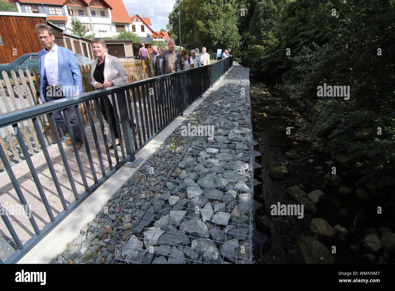 05 September 2019, Saxony-Anhalt, Ilsenburg: Representatives of the Ministry of the Environment of Saxony-Anhalt, the city of Ilsenburg as well as involved construction companies met to visit the bank wall at the Ilse after restoration in the course of the removal of flood damages. In the year 2017 the bank wall at the Ilse collapsed in the course of the flood. Photo: Matthias Bein/dpa-Zentralbild/ZB Stock Photo